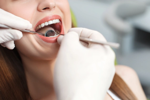 Dental hygienist performing a thorough teeth cleaning.