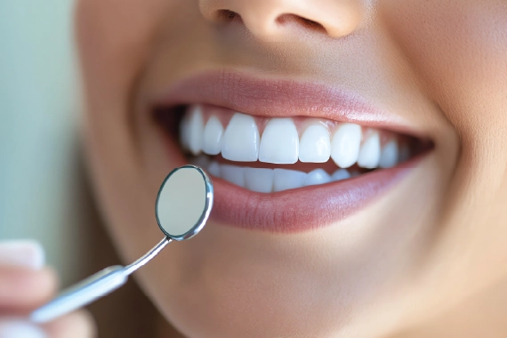 A smiling person showcasing white, straight teeth to highlight cosmetic dentistry benefits.