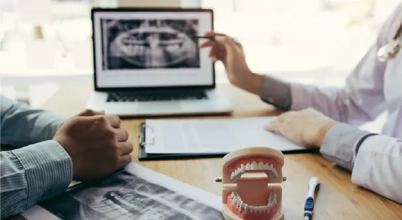 A friendly dentist assisting a family with dental care.